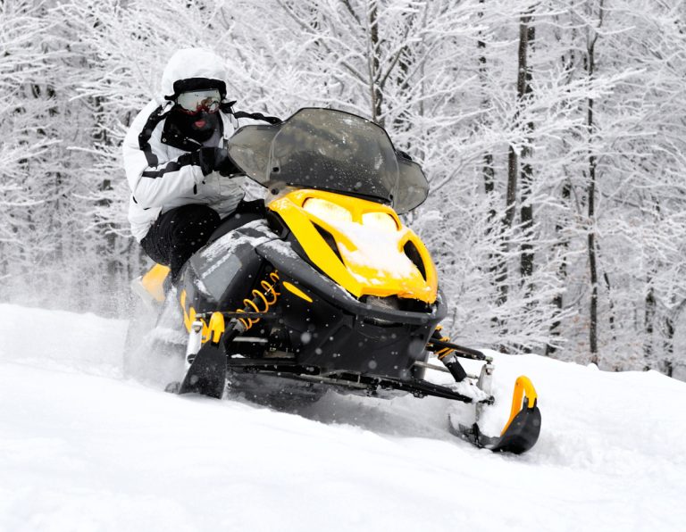 Man on snowmobile in winter mountain