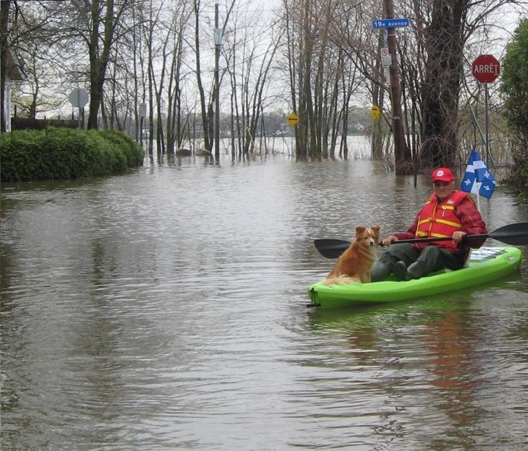 Accompagné de son chien, Richard Lamothe doit circuler en kayak près de chez lui, 19e Avenue, dans Laval-Ouest.