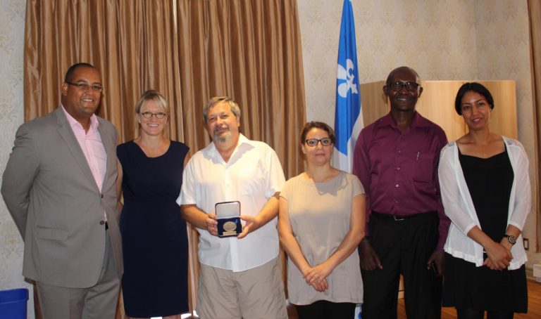 Le député de Laval-des-Rapides Saul Polo pose en compagnie de Claire Le Bel, directrice générale de L'Entraide; Lucian Nica, directeur du secteur Immigration à L'Entraide; Nadia Belaid, agente de liaison; Pierre Célestin Nkubito, agent d’accueil; et Nadia El Ouchchama, agent de bureau.